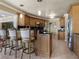 Kitchen island featuring granite countertops, stainless steel appliances, pendant lighting, and custom cabinetry at 7614 Peninsular Dr, Sarasota, FL 34231