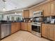 Well-lit kitchen with stainless steel appliances and granite countertops overlooking the water at 7614 Peninsular Dr, Sarasota, FL 34231