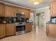 Well-lit kitchen with stainless steel oven, microwave, granite countertops and light wood cabinets at 7614 Peninsular Dr, Sarasota, FL 34231