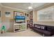 Cozy living room features built-in shelving and a comfortable sofa for relaxing at 7614 Peninsular Dr, Sarasota, FL 34231
