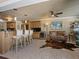 Bright open living space with kitchen and seating area with tile floors and stainless appliances at 7614 Peninsular Dr, Sarasota, FL 34231