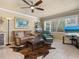 Bright open living space with kitchen and seating area with tile floors, large windows, and plenty of sunlight at 7614 Peninsular Dr, Sarasota, FL 34231