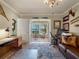 Home office with a view of the water and an eccentric chandelier at 7614 Peninsular Dr, Sarasota, FL 34231