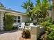 Inviting outdoor seating area with a view of lush landscaping and privacy at 7614 Peninsular Dr, Sarasota, FL 34231