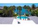 Beautiful pool view with palm trees and water access at 7614 Peninsular Dr, Sarasota, FL 34231