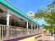 Exterior view of colorful restaurant with outdoor seating, wooden deck, and street view at 7614 Peninsular Dr, Sarasota, FL 34231