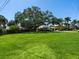 Expansive lawn and mature tree offer a picturesque setting for this well-maintained property at 7614 Peninsular Dr, Sarasota, FL 34231