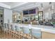Community bar area with barstool seating, liquor displays, flat screen televisions, and view to the outside at 7838 Bowspirit Way, Lakewood Ranch, FL 34202