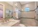 Light bathroom features a large mirror, walk-in shower with gray tile, and a single sink vanity at 7838 Bowspirit Way, Lakewood Ranch, FL 34202