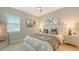 Well-lit bedroom with a cozy bed, decorative mirrors, and soft lighting perfect for relaxation at 7838 Bowspirit Way, Lakewood Ranch, FL 34202