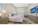 Luxurious bedroom with tray ceilings, chandelier, a sitting area and access to the pool at 7838 Bowspirit Way, Lakewood Ranch, FL 34202