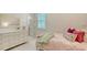 Bright bedroom featuring a dresser, neutral tones, stylish decor and lots of natural light at 7838 Bowspirit Way, Lakewood Ranch, FL 34202