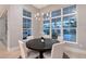 Bright dining room features a round table, chandelier lighting, and large windows overlooking the backyard at 7838 Bowspirit Way, Lakewood Ranch, FL 34202
