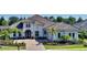 Gorgeous home with a well-manicured lawn, tile roof, and stylish architectural details at 7838 Bowspirit Way, Lakewood Ranch, FL 34202