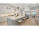 Bright kitchen featuring a spacious island with seating, modern appliances, and white cabinetry at 7838 Bowspirit Way, Lakewood Ranch, FL 34202