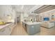 Open-concept kitchen featuring a large island, stainless steel appliances, and seamless flow to the living area at 7838 Bowspirit Way, Lakewood Ranch, FL 34202
