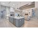 Open-concept kitchen featuring a large island, stainless steel appliances, and seamless flow to the living area at 7838 Bowspirit Way, Lakewood Ranch, FL 34202