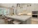 Bright kitchen featuring a spacious island with seating, modern appliances, and stylish light fixtures at 7838 Bowspirit Way, Lakewood Ranch, FL 34202