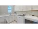 Convenient laundry room offers lots of storage and new washer and dryer at 7838 Bowspirit Way, Lakewood Ranch, FL 34202
