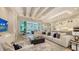 Bright living room with a modern sectional sofa, chandelier, and backyard pool access at 7838 Bowspirit Way, Lakewood Ranch, FL 34202