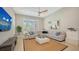 Spacious living room boasts a large sectional sofa, ceiling fan, and a wall-mounted television for entertaining at 7838 Bowspirit Way, Lakewood Ranch, FL 34202