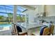 Outdoor kitchen with granite countertop, stainless steel grill, sink and barstool seating at 7838 Bowspirit Way, Lakewood Ranch, FL 34202