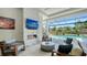 Stylish outdoor living area with a fireplace, TV, comfortable seating and view of pool at 7838 Bowspirit Way, Lakewood Ranch, FL 34202