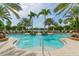 Inviting community pool surrounded by lush greenery and palm trees, offering a luxurious retreat at 7838 Bowspirit Way, Lakewood Ranch, FL 34202