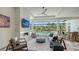Relaxing covered patio featuring an outdoor kitchen and seating area with views of the luxurious pool and backyard at 7838 Bowspirit Way, Lakewood Ranch, FL 34202