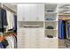 Well-organized walk-in closet featuring ample shelving, cabinets, drawers, and hanging space at 7838 Bowspirit Way, Lakewood Ranch, FL 34202