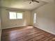Bright bedroom featuring wood-look floors and a ceiling fan at 8040 Canterbury Cir, Seminole, FL 33777