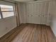 Bedroom featuring wood floors and a large closet at 8040 Canterbury Cir, Seminole, FL 33777