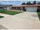 Charming single-story home with a well-manicured lawn and inviting curb appeal at 8040 Canterbury Cir, Seminole, FL 33777