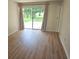 Spacious living room featuring sliding glass doors, new floors, and neutral paint at 8040 Canterbury Cir, Seminole, FL 33777