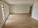 Spacious living room with new flooring, bright windows, and neutral paint at 8040 Canterbury Cir, Seminole, FL 33777
