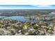 Aerial view of a waterfront community featuring lush greenery, a beautiful river, and modern homes at 805 Padua Ct, Nokomis, FL 34275
