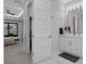 Bright bathroom with a white vanity, elegant fixtures, and a view into the bedroom and walk-in closet at 805 Padua Ct, Nokomis, FL 34275