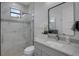 Beautiful bathroom featuring an oversized glass shower, stylish vanity, and modern fixtures at 805 Padua Ct, Nokomis, FL 34275