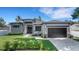 Beautiful modern home featuring stone accents, professional landscaping, and a freshly sealed driveway at 805 Padua Ct, Nokomis, FL 34275