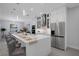 Modern kitchen with a large center island, stainless steel appliances, and an open floor plan at 805 Padua Ct, Nokomis, FL 34275
