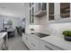Modern kitchen featuring white cabinets, stainless steel appliances, and stylish backsplash at 805 Padua Ct, Nokomis, FL 34275