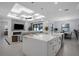 Bright, open kitchen featuring a large island, which overlooks the living room with fireplace at 805 Padua Ct, Nokomis, FL 34275