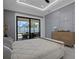 Bright main bedroom offering a view of the outdoor living and dining area at 805 Padua Ct, Nokomis, FL 34275