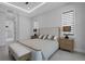Bright main bedroom with en-suite bathroom access and view of large windows at 805 Padua Ct, Nokomis, FL 34275