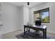 Bright home office featuring a large window, dark wood desk, and stylish rug at 805 Padua Ct, Nokomis, FL 34275