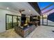 Captivating outdoor living space featuring a fire pit, summer kitchen, and screened-in patio area at 805 Padua Ct, Nokomis, FL 34275