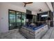 Covered outdoor living area with ample seating, summer kitchen, and views of the pool at 805 Padua Ct, Nokomis, FL 34275