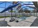 Screened-in pool and hot tub area with lounge chairs, surrounded by a well-manicured lawn at 805 Padua Ct, Nokomis, FL 34275