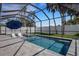 Sparkling screened-in pool and hot tub with lounge chairs and a beautifully landscaped backyard at 805 Padua Ct, Nokomis, FL 34275