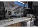 Outdoor kitchen featuring marbled backsplash, prep-sink, built-in grill, and refrigeration at 805 Padua Ct, Nokomis, FL 34275